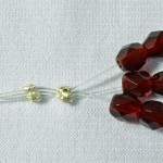 Using a crimp to secure multiple strands of beads