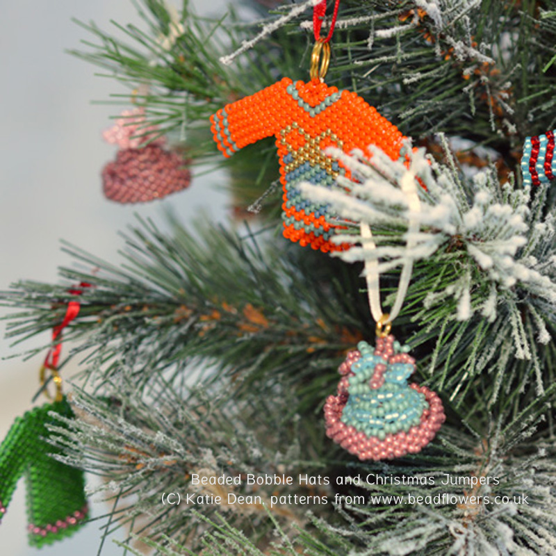 Beaded bobble hats and Christmas jumpers on a Christmas tree, Katie Dean
