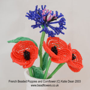 Beading patterns for poppies. Display of French beaded poppies and cornflower by Katie Dean
